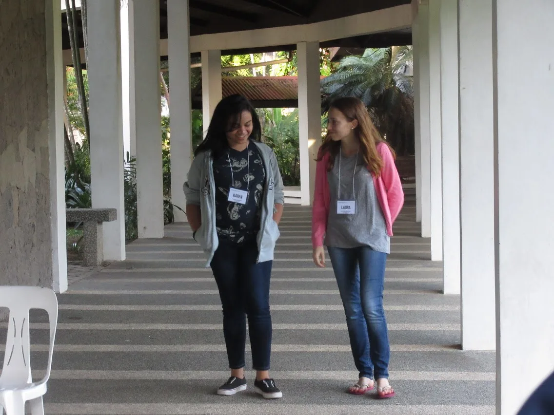 Two Aiducation alumni walking and talking together at a Academy in the Philippines